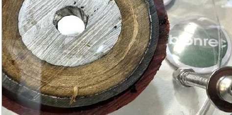Cored disc cut from a treated cable showing clean, dry paper insulation